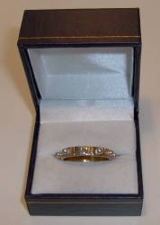 Bond is given a demonstration of this sonic ring in his lab. Q tells Bond that a sheet of unbreakable bulletproof glass is shattered when the ring is twisted, sending out an extremely high frequency. Bond uses the ring twice in Die Another Day. Firstly to escape from being held at gunpoint by Miranda Frost, as the glass floor they are standing on shatters when Bond uses the ring. Finally, Bond uses the ring to break the glass of his Aston Martin to save Jinx�s life.